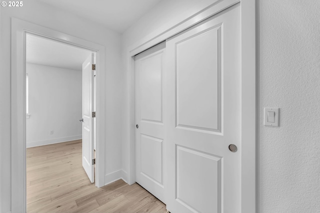 2928 S Harper Valley Way, Ridgefield, WA 98642 - hall featuring light wood-type flooring, a textured wall, and baseboards