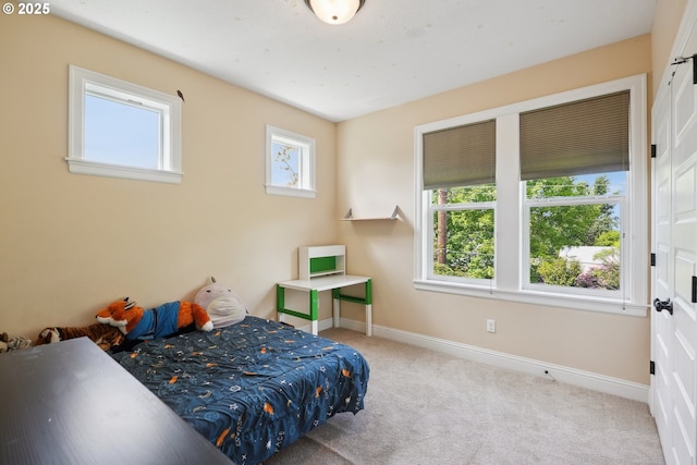 carpeted bedroom featuring baseboards