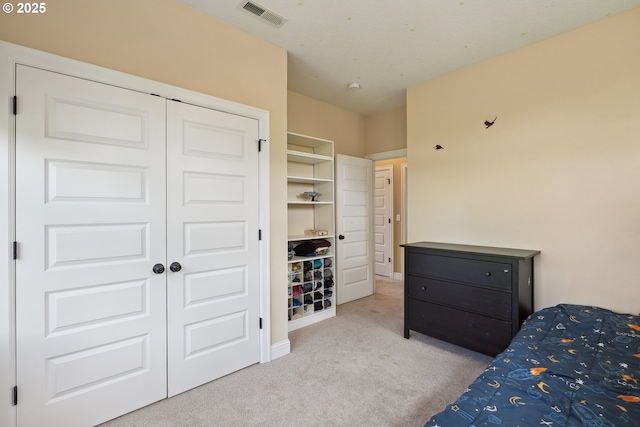 bedroom featuring carpet and a closet