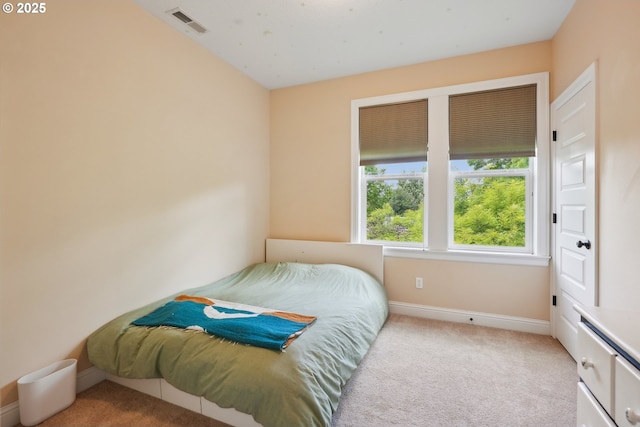 carpeted bedroom featuring baseboards