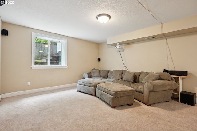 carpeted living area with a textured ceiling and baseboards