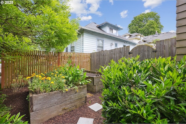 view of yard with a vegetable garden and fence
