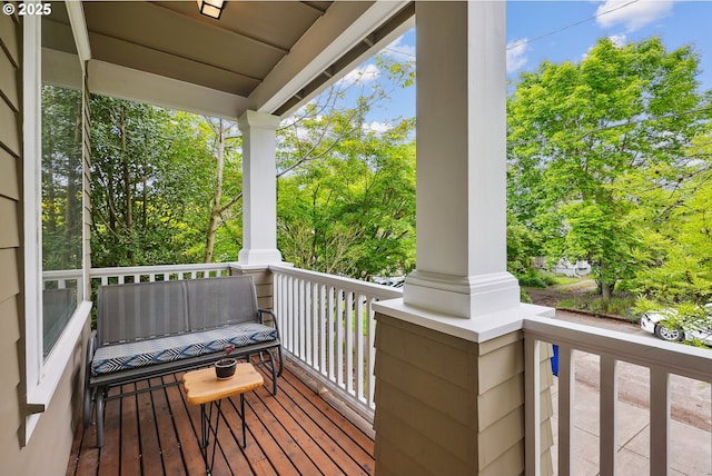 wooden terrace with view of scattered trees