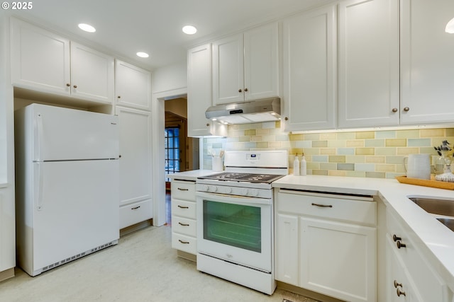 kitchen featuring under cabinet range hood, backsplash, white cabinetry, white appliances, and light countertops