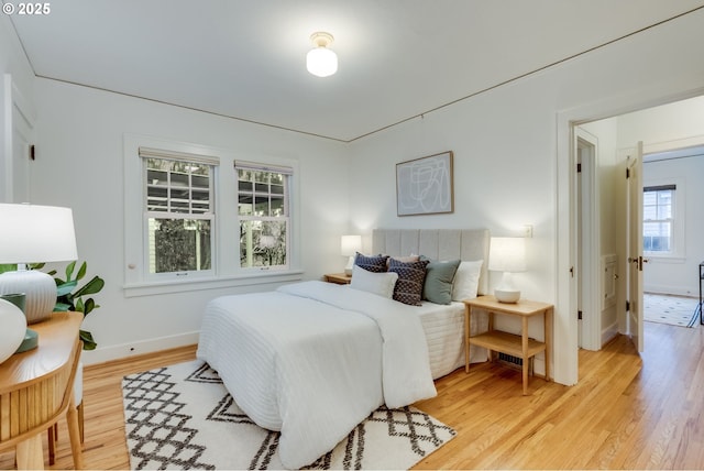 bedroom with baseboards and light wood-style floors