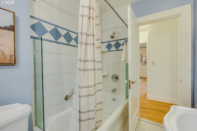 full bath with baseboards, toilet, and shower / bath combination with curtain