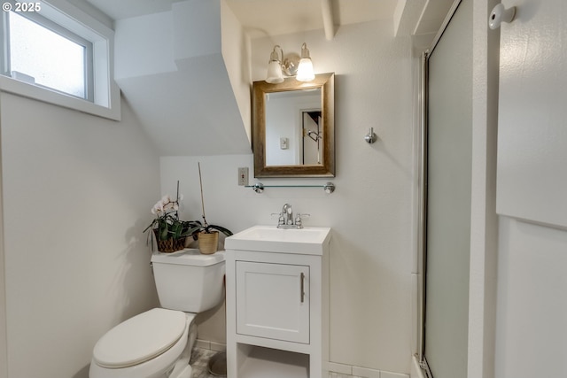 full bathroom featuring vanity, a shower stall, toilet, and vaulted ceiling