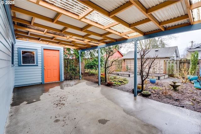 view of patio with a garden and fence