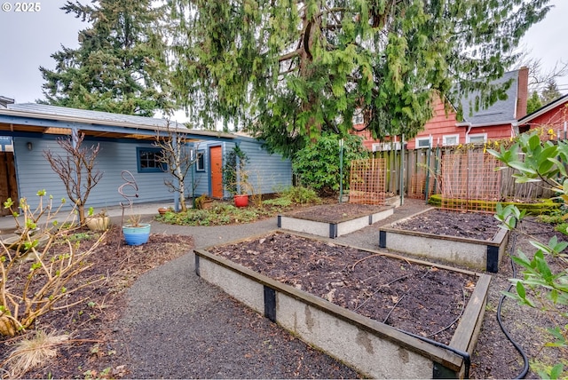 view of yard with a vegetable garden and fence