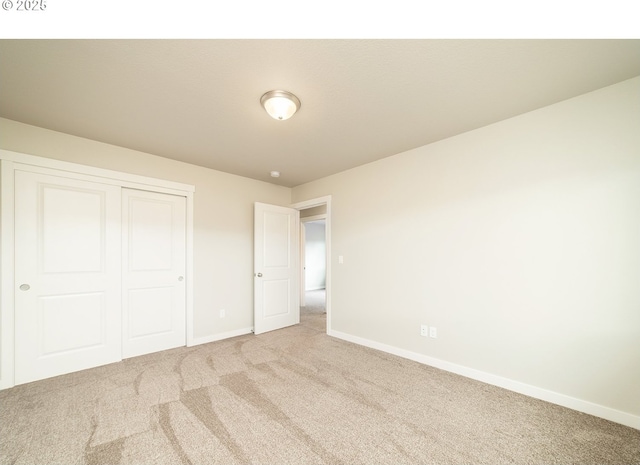 unfurnished bedroom with light carpet and a closet