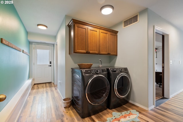 4330 Mcminnville Ave, Neskowin, OR 97149 - washroom with cabinet space, washer and dryer, and light wood-style flooring
