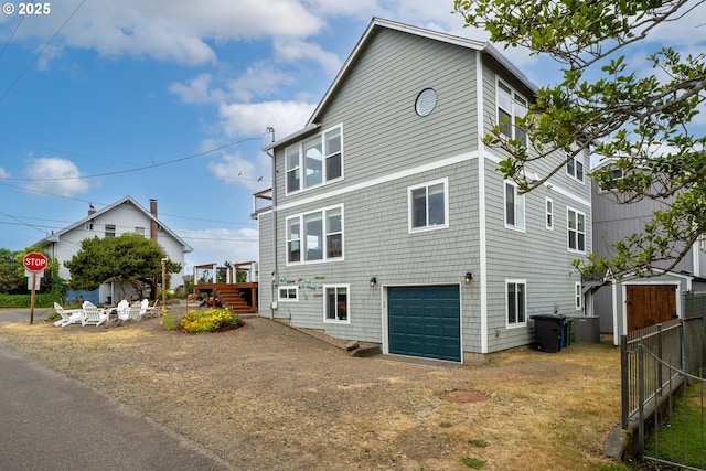 4330 Mcminnville Ave, Neskowin, OR 97149 - view of front of house with an attached garage, dirt driveway, and stairs