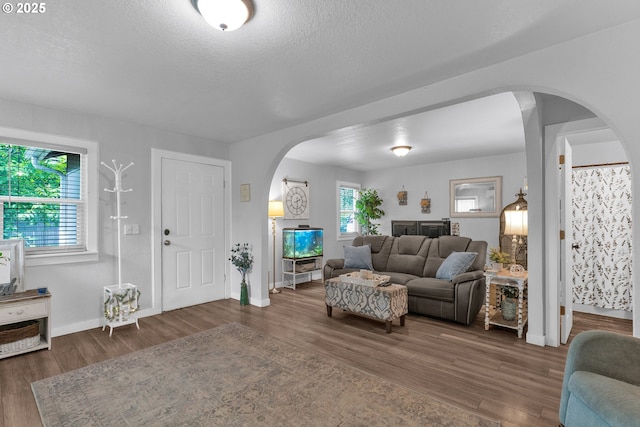 3911 E 16th Ave, Eugene, OR 97403 - living room with arched walkways, wood finished floors, and a textured ceiling