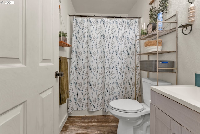 3911 E 16th Ave, Eugene, OR 97403 - bathroom featuring wood finished floors, vanity, and curtained shower