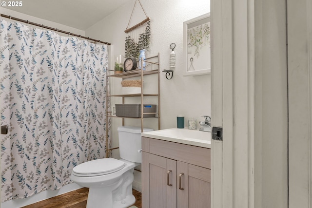 3911 E 16th Ave, Eugene, OR 97403 - bathroom with vanity, a shower with shower curtain, and wood finished floors