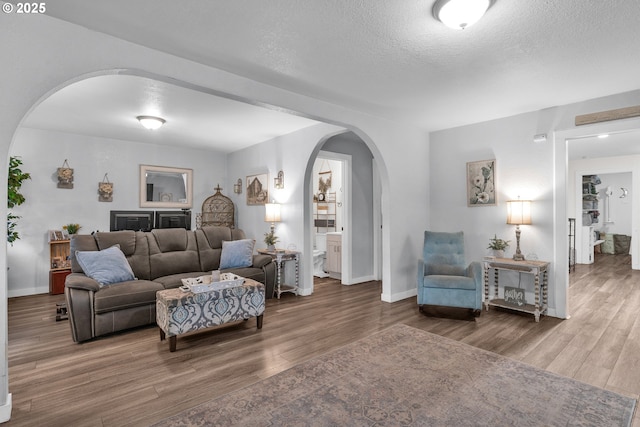 3911 E 16th Ave, Eugene, OR 97403 - living area with arched walkways, wood finished floors, and a textured ceiling