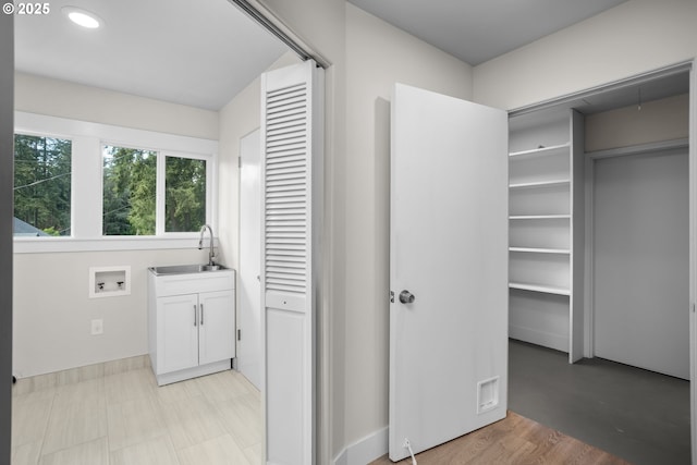 clothes washing area featuring washer hookup, cabinet space, recessed lighting, and a sink