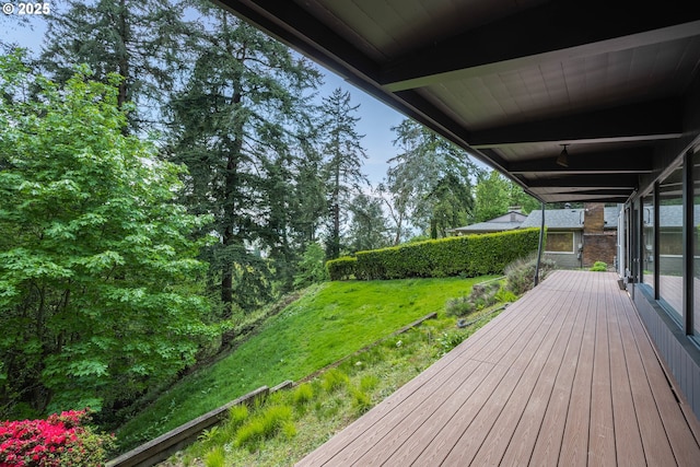 wooden terrace with a lawn