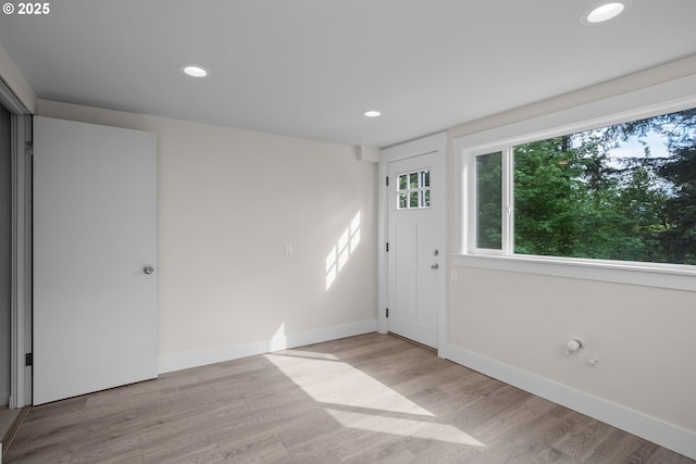 foyer featuring recessed lighting, baseboards, and light wood-style floors