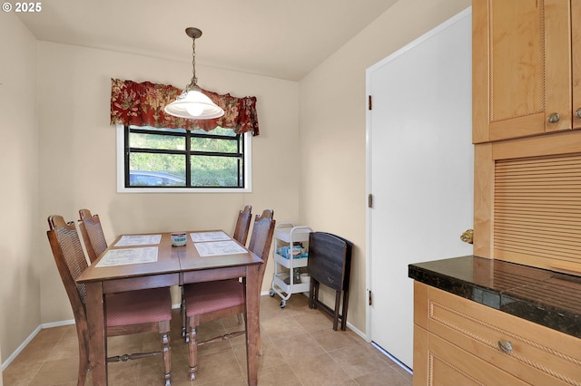 dining space with light tile patterned floors and baseboards