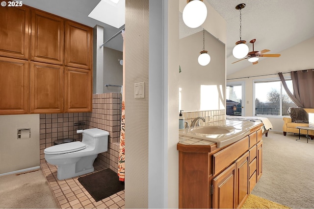 full bathroom featuring toilet, ceiling fan, lofted ceiling, and vanity