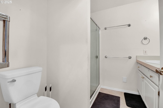full bath featuring tile patterned flooring, vanity, baseboards, toilet, and a shower with door