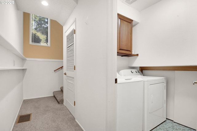 washroom with visible vents, recessed lighting, cabinet space, and separate washer and dryer