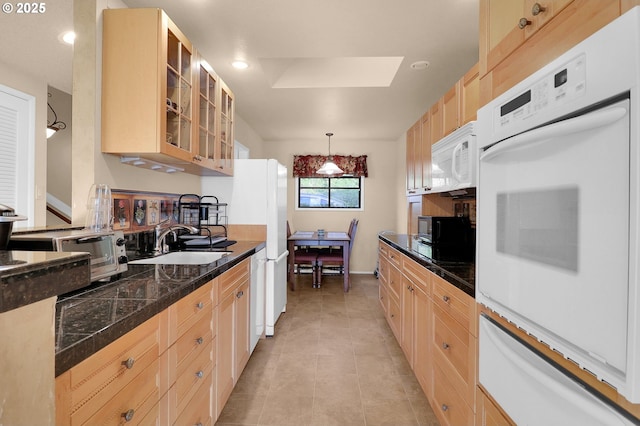 kitchen featuring a sink, white appliances, tile counters, glass insert cabinets, and a warming drawer
