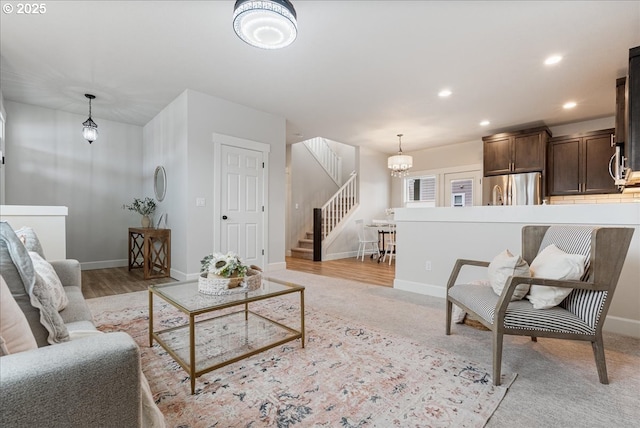 living area with an inviting chandelier, stairway, recessed lighting, and baseboards