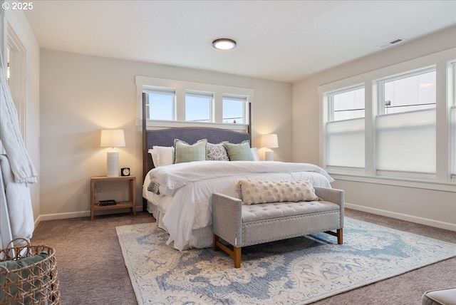 bedroom with visible vents, carpet flooring, and baseboards