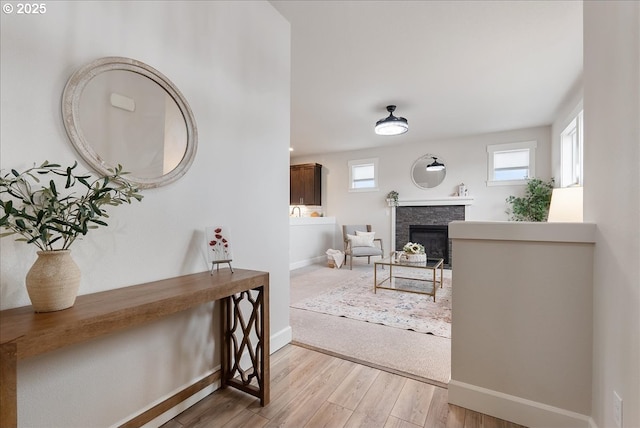 interior space with a fireplace, wood finished floors, and baseboards