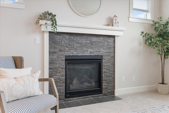 details with a fireplace with flush hearth, baseboards, and carpet floors
