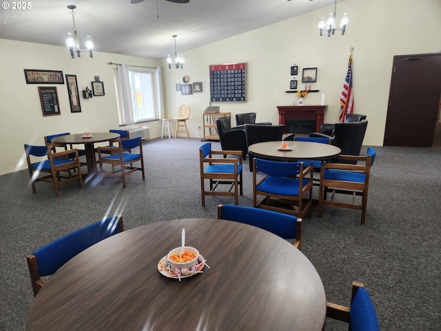 950 Evergreen Rd Unit 109, Woodburn, OR 97071 - carpeted dining area featuring a chandelier, a ceiling fan, and a fireplace