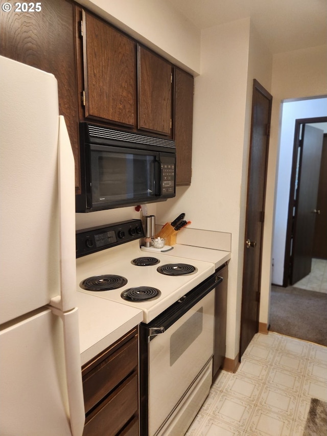 950 Evergreen Rd Unit 109, Woodburn, OR 97071 - kitchen featuring white appliances, light countertops, and dark brown cabinets
