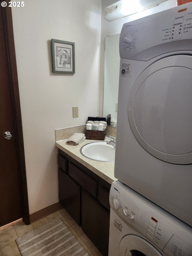 950 Evergreen Rd Unit 109, Woodburn, OR 97071 - bathroom featuring stacked washer and clothes dryer, vanity, tile patterned flooring, and baseboards
