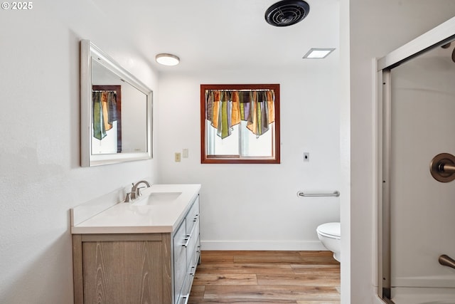 6901 SE Oaks Park Way Unit 1, Portland, OR 97202 - full bathroom featuring vanity, wood finished floors, an enclosed shower, and toilet