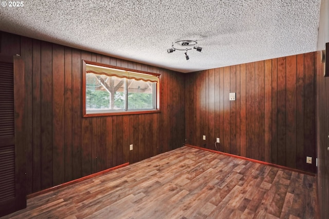 6901 SE Oaks Park Way Unit 1, Portland, OR 97202 - spare room featuring wood finished floors, a textured ceiling, and wooden walls