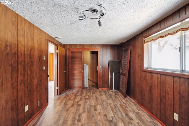 6901 SE Oaks Park Way Unit 1, Portland, OR 97202 - spare room with a textured ceiling, wood walls, and wood finished floors