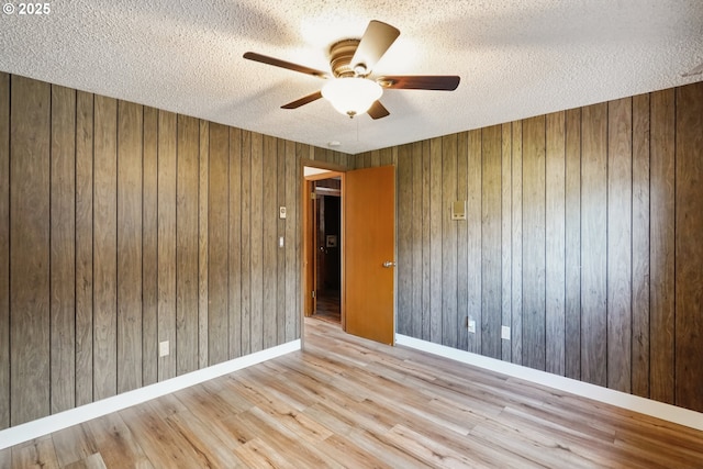 6901 SE Oaks Park Way Unit 1, Portland, OR 97202 - spare room with a textured ceiling, ceiling fan, wood finished floors, wooden walls, and baseboards