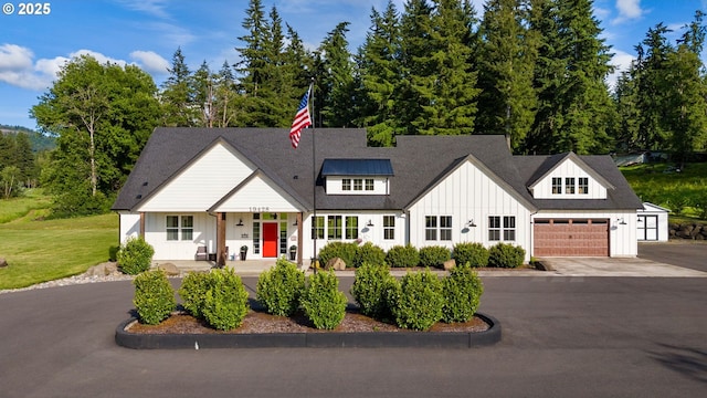 19428 NE 259th St, Battle Ground, WA 98604 - modern inspired farmhouse featuring board and batten siding, asphalt driveway, a porch, and a front lawn