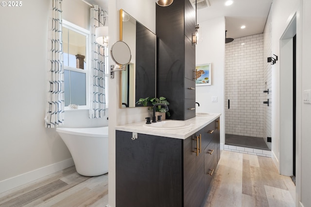 19428 NE 259th St, Battle Ground, WA 98604 - full bath featuring a stall shower, wood finished floors, double vanity, a freestanding bath, and recessed lighting