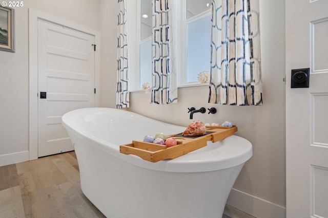 19428 NE 259th St, Battle Ground, WA 98604 - bathroom featuring wood finished floors, a soaking tub, and baseboards