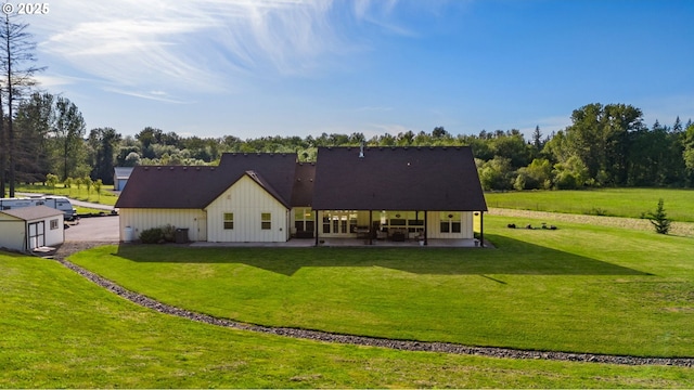 19428 NE 259th St, Battle Ground, WA 98604 - back of house featuring a patio, a lawn, and board and batten siding