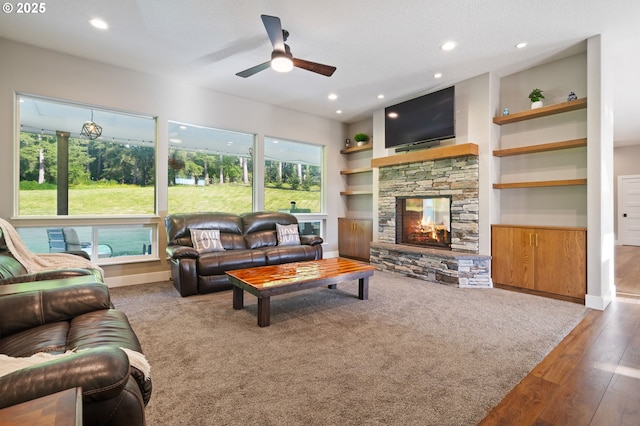 19428 NE 259th St, Battle Ground, WA 98604 - living room with a ceiling fan, a stone fireplace, built in shelves, baseboards, and recessed lighting