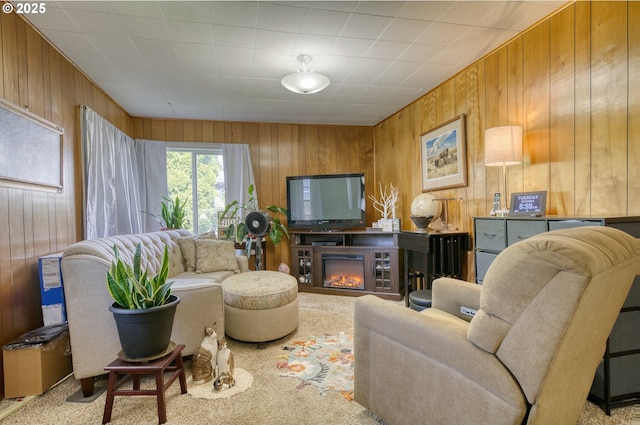 33855 NE Blossom Dr, Scappoose, OR 97056 - living room featuring wooden walls, a glass covered fireplace, and carpet floors