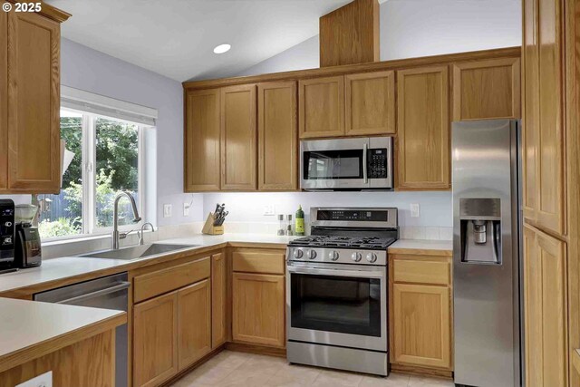 5986 Rombauer Rd, Eugene, OR 97402 - kitchen with stainless steel appliances, lofted ceiling, light countertops, recessed lighting, and brown cabinets