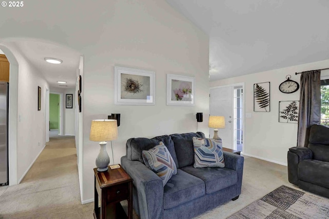 5986 Rombauer Rd, Eugene, OR 97402 - living area featuring light carpet, arched walkways, and vaulted ceiling