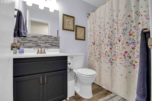5986 Rombauer Rd, Eugene, OR 97402 - bathroom with decorative backsplash, wood finished floors, vanity, and a shower with shower curtain