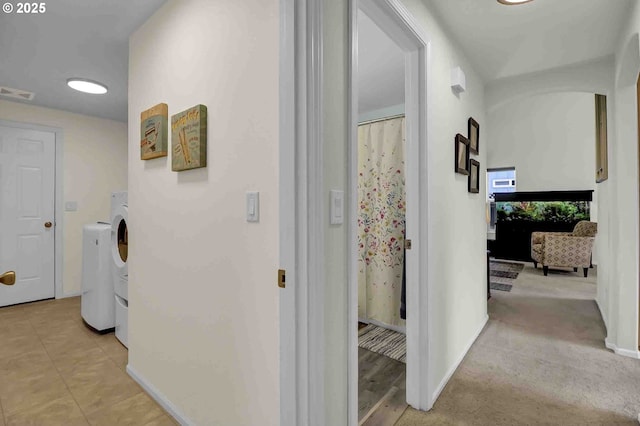 5986 Rombauer Rd, Eugene, OR 97402 - hallway featuring separate washer and dryer and baseboards