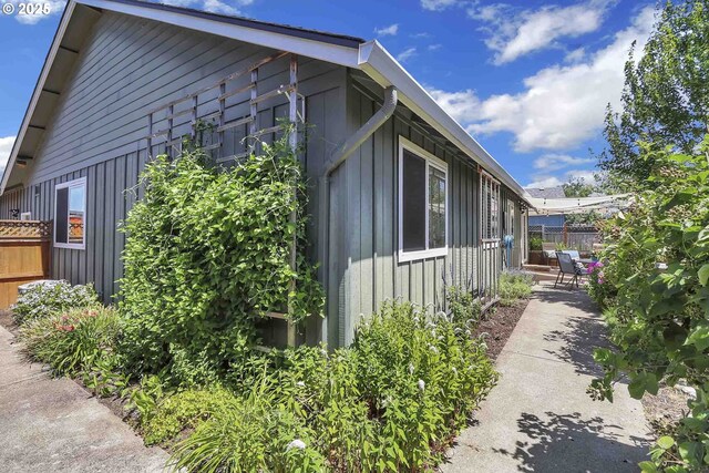 5986 Rombauer Rd, Eugene, OR 97402 - view of side of home featuring board and batten siding and a patio